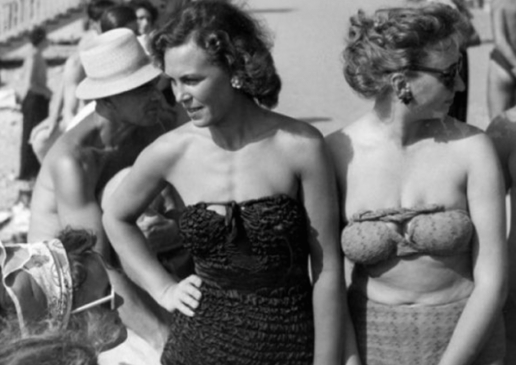 Two women in contrasting swimsuits at Soviet beach